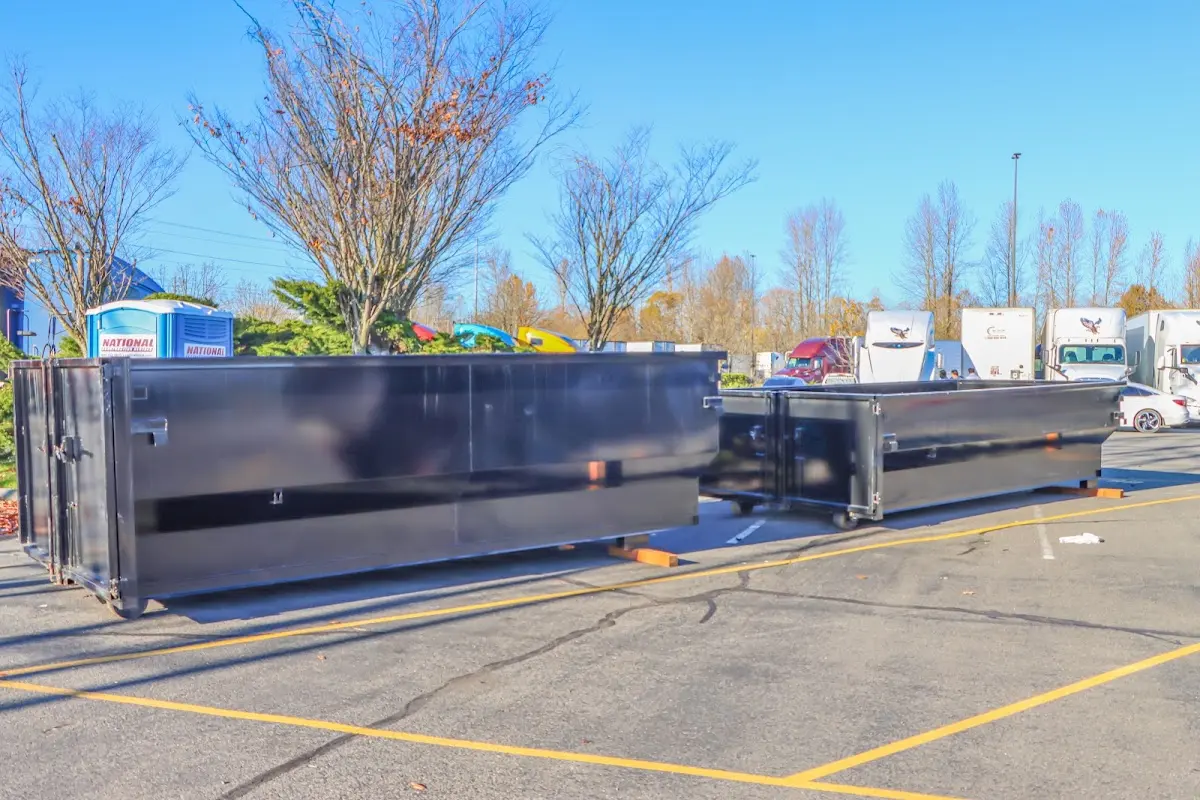 Professional dumpster rental service with roll-off container on residential driveway in Lacey